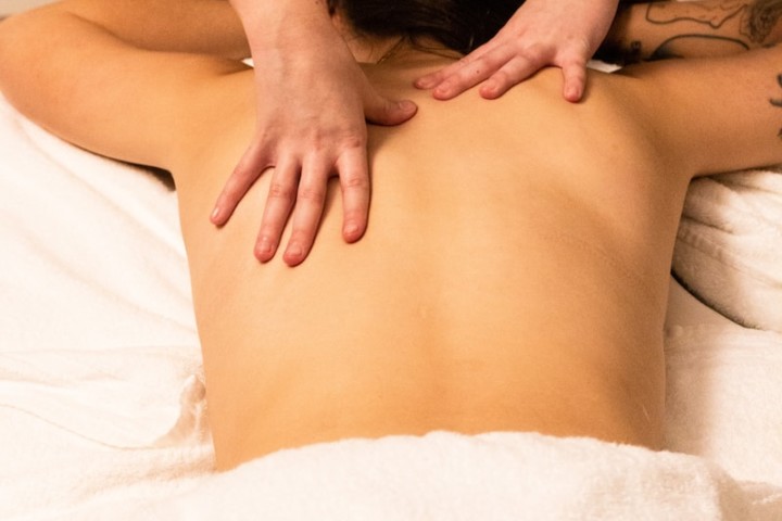 a woman getting a back massage at a spa